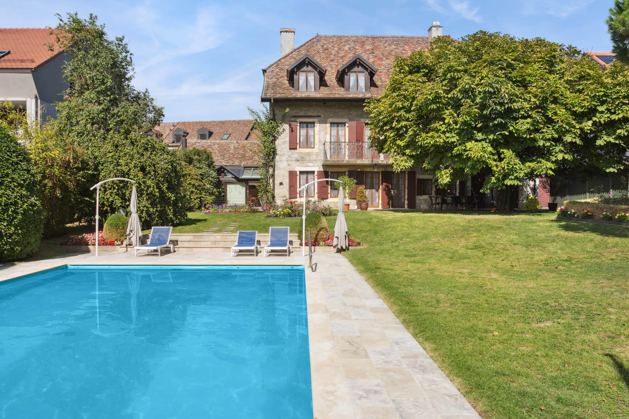 Elegant 19th Century Village-Style Property with Outdoor Pool and Expansive Wooded Grounds